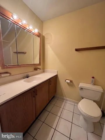 a bathroom with a sink mirror vanity and toilet