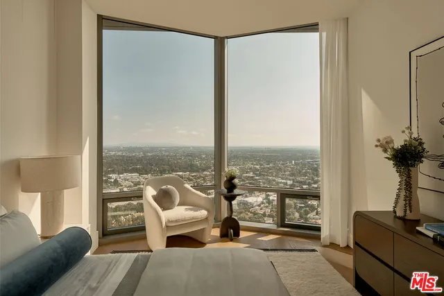 a living room with furniture and a floor to ceiling window