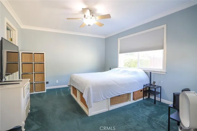 a spacious bedroom with a bed and a chandelier