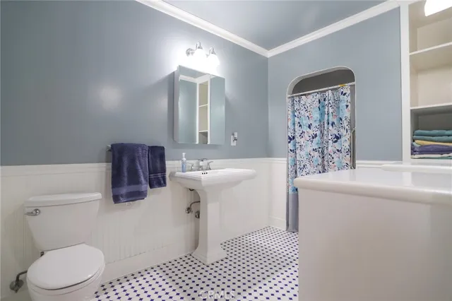 a bathroom with a sink toilet and mirror
