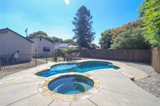 a backyard of a house with table and chairs