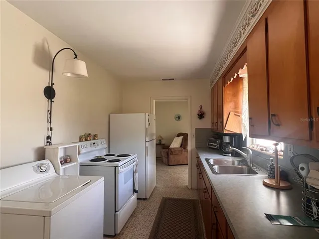 a kitchen with a sink appliances and cabinets