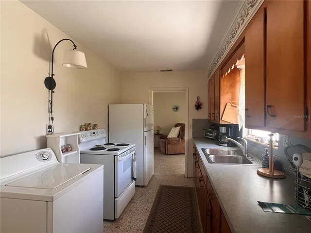 a kitchen with a sink appliances and cabinets