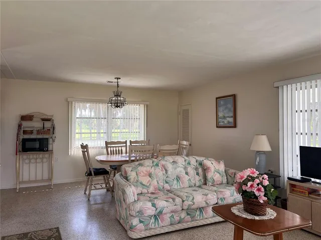 a living room with furniture fireplace and window