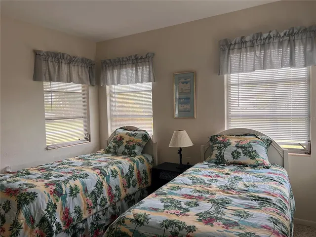 a bedroom with two beds and a window