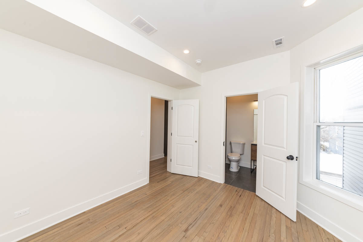 2825 North Rockwell Street, Unit 2 Chicago, IL 60618 - Photo 12 of 22 a view of a livingroom with a hardwood floor and a window