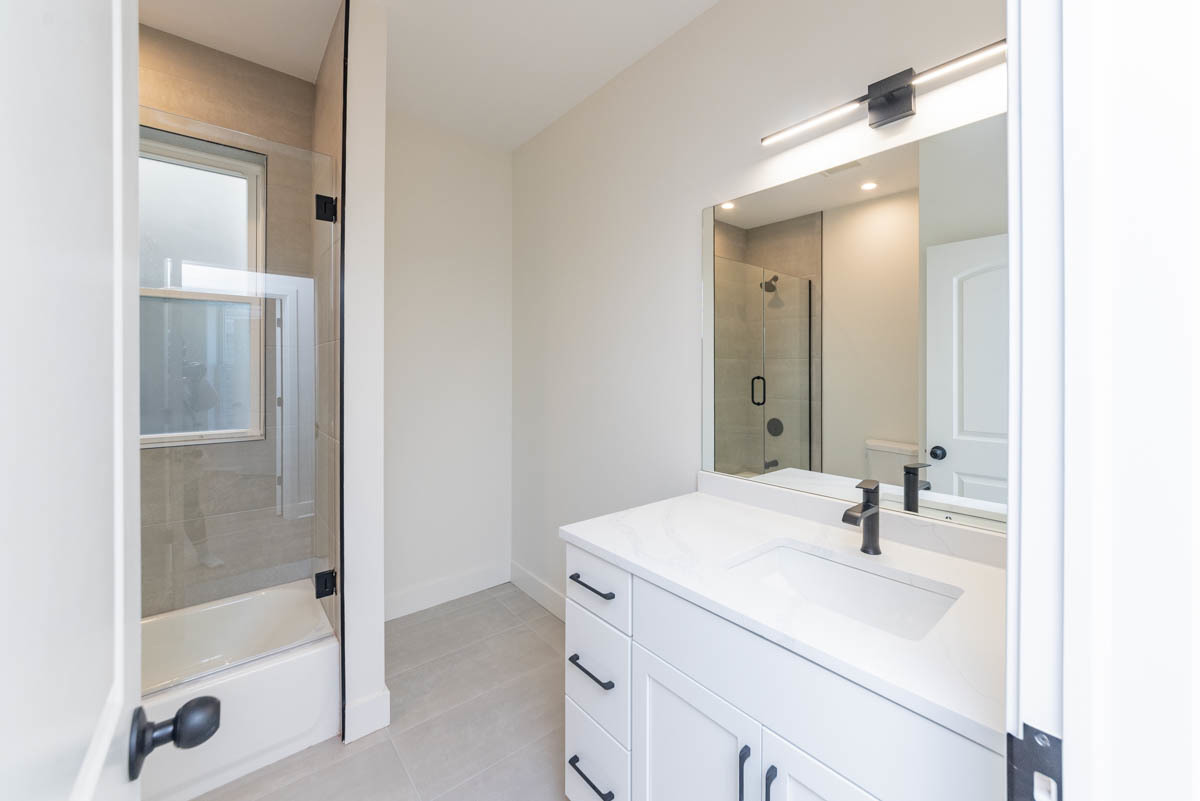 2825 North Rockwell Street, Unit 2 Chicago, IL 60618 - Photo 15 of 22 a bathroom with a bathtub shower sink vanity and mirror