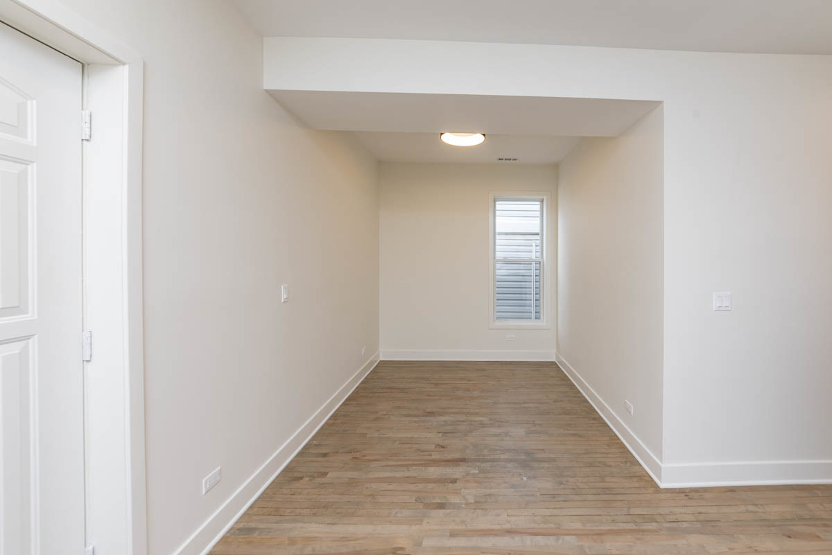 2825 North Rockwell Street, Unit 2 Chicago, IL 60618 - Photo 17 of 22 a view of an empty room with wooden floor and a window