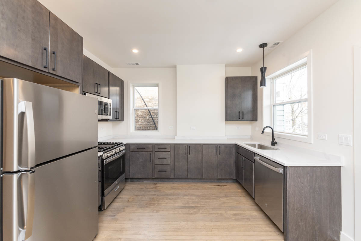 2825 North Rockwell Street, Unit 2 Chicago, IL 60618 - Photo 3 of 22 a kitchen with granite countertop a refrigerator and a sink