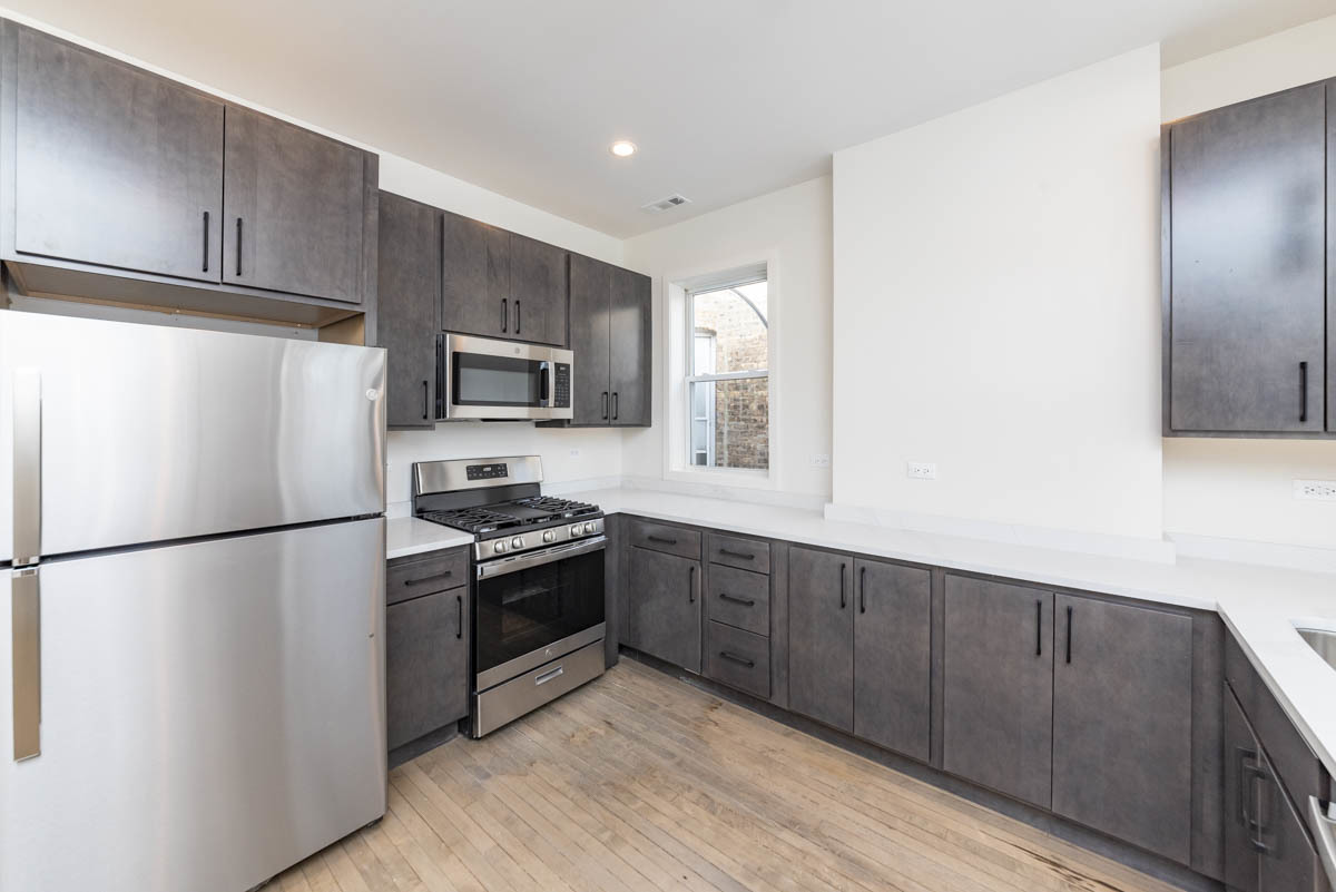 2825 North Rockwell Street, Unit 2 Chicago, IL 60618 - Photo 4 of 22 a kitchen with stainless steel appliances granite countertop a refrigerator stove a sink and dishwasher