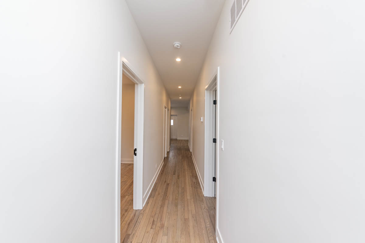 2825 North Rockwell Street, Unit 2 Chicago, IL 60618 - Photo 8 of 22 a view of a hallway with wooden floor