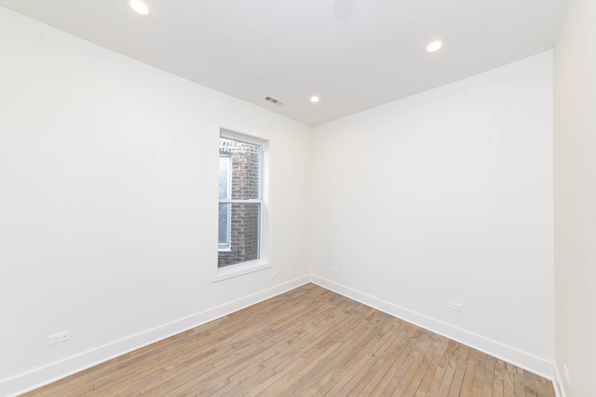 2825 North Rockwell Street, Unit 2 Chicago, IL 60618 - Photo 9 of 22 a view of empty room with wooden floor and fan