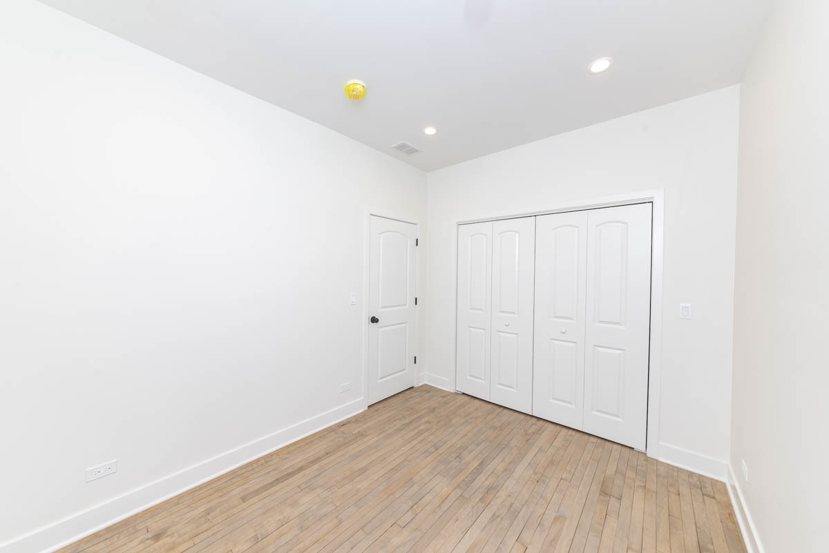 2825 North Rockwell Street, Unit 2 Chicago, IL 60618 - Photo 10 of 22 a view of an empty room with wooden floor