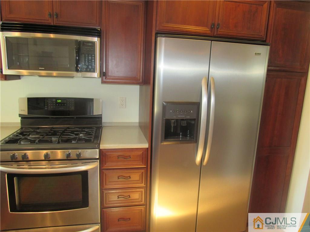 3 Hillsdale Road Edison, NJ 08820 - Photo 4 of 27 a kitchen with a stove and a microwave