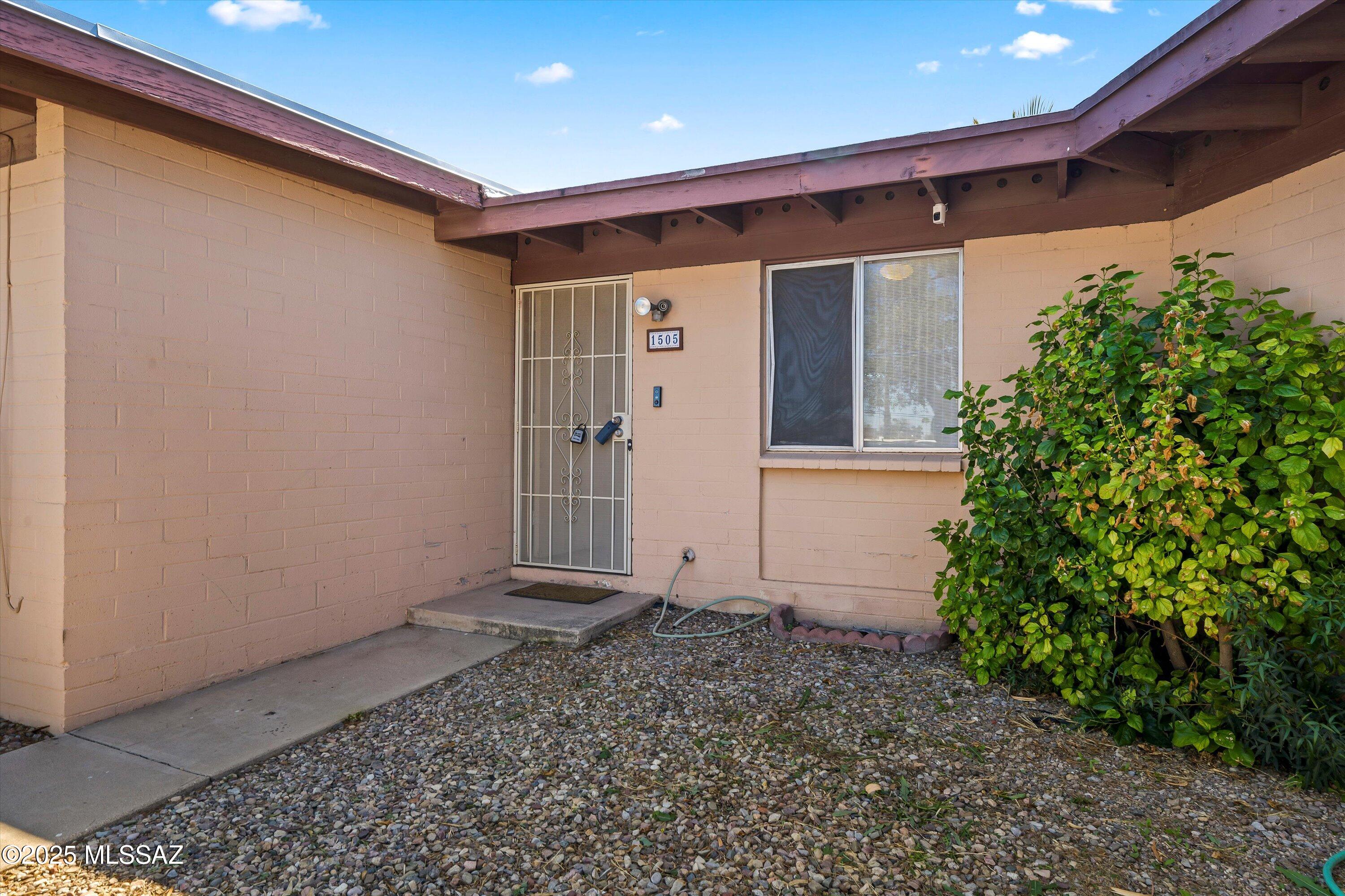 1505 West Roger Road Tucson, AZ 85705 - Photo 1 of 24 a front view of a house with a yard