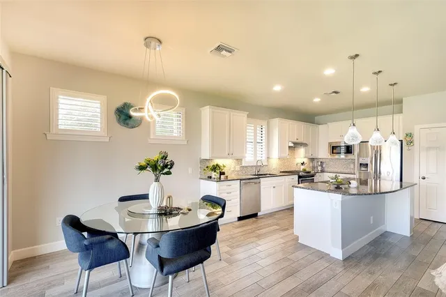 a kitchen with center island and cabinets