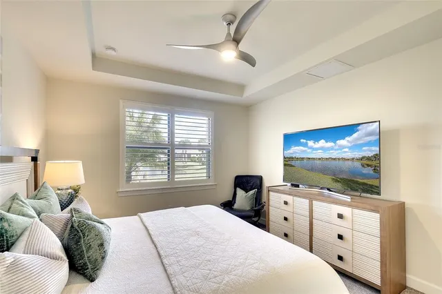 a bedroom with furniture and a flat screen tv