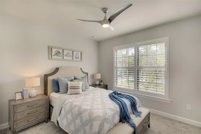 a bedroom with a large bed and a window