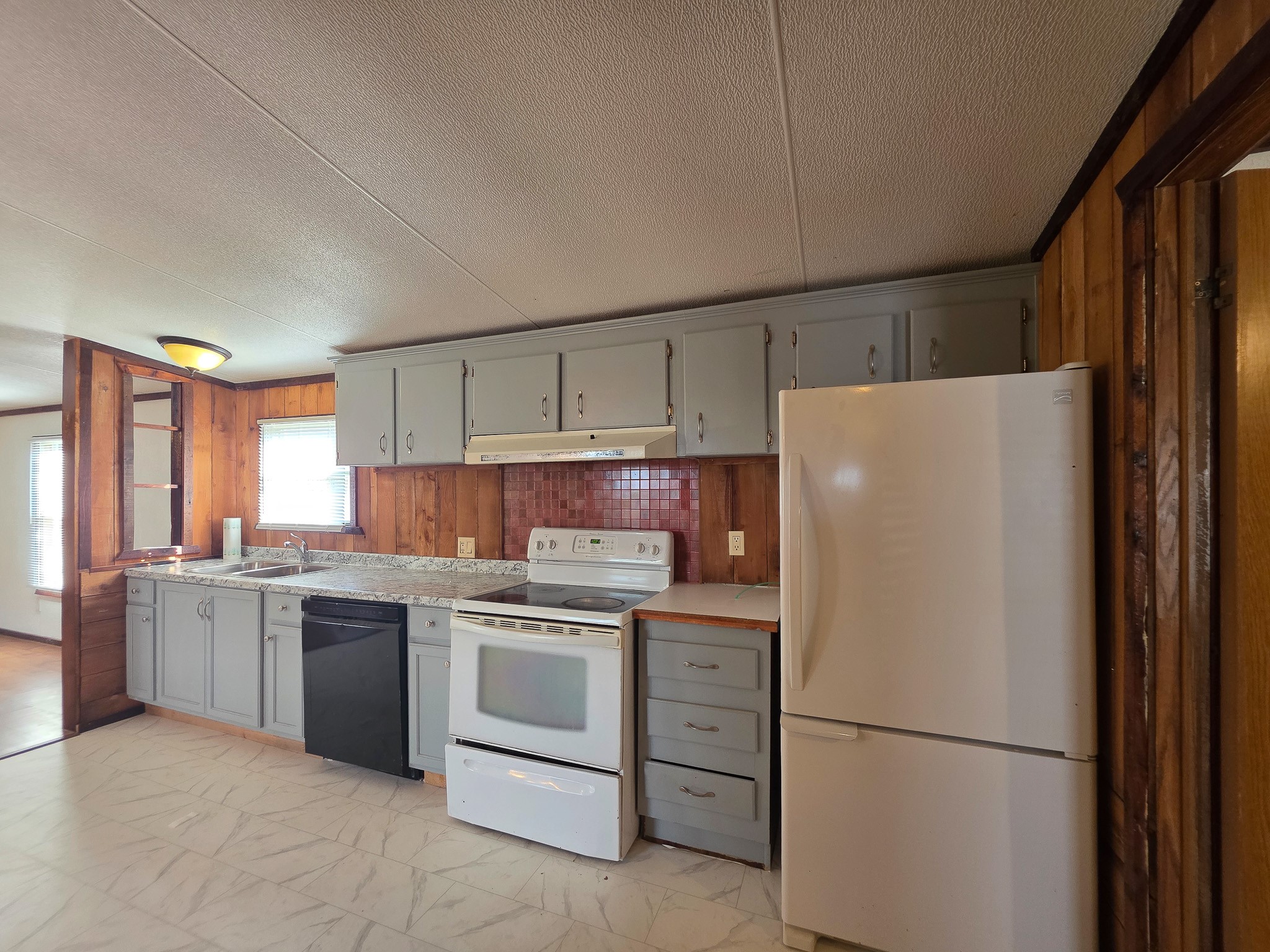 344 Holmes Road Onalaska, TX 77360 - Photo 10 of 25 309 Holmes view from laundry room into the kitchen