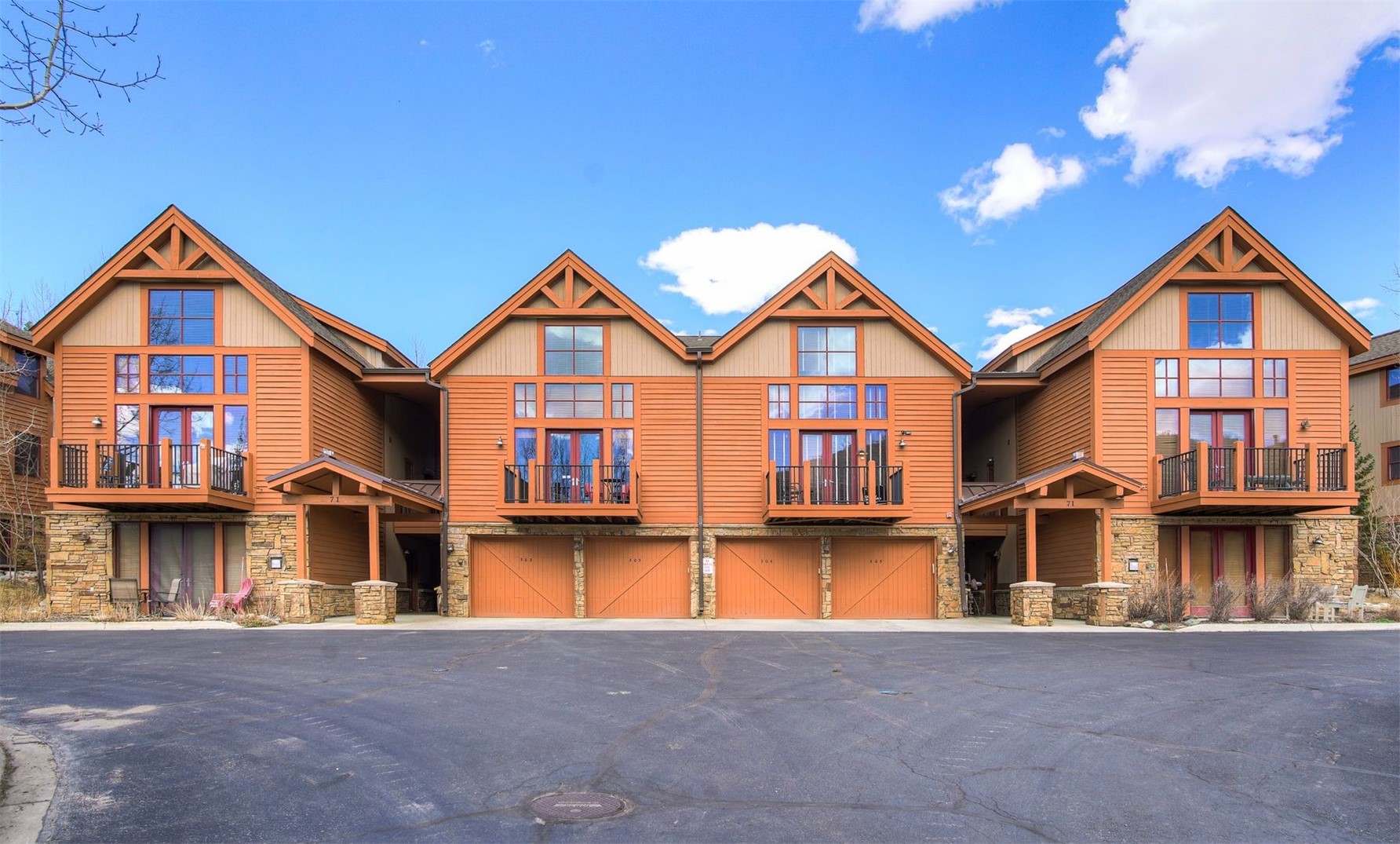71 Antlers Gulch Road, Unit 303 Keystone, CO 80435 - Photo 28 of 35 a view of a big house with large windows and a yard