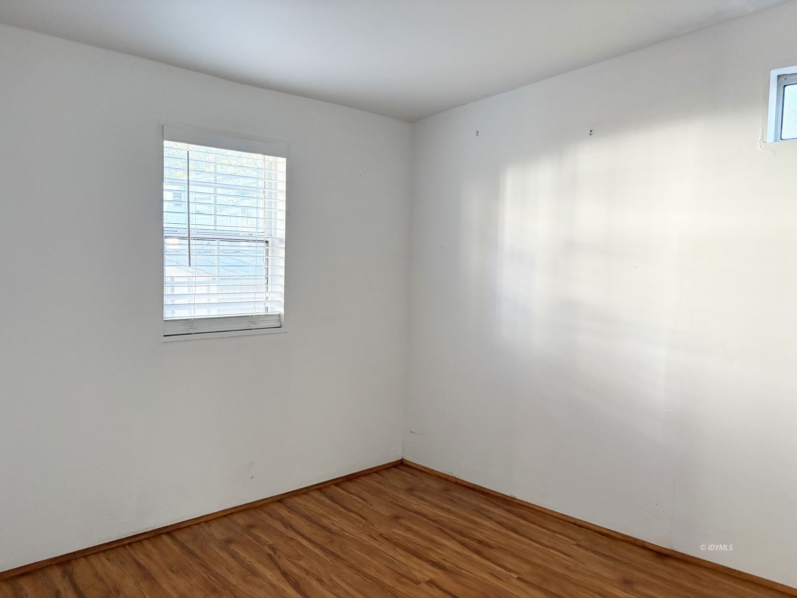 25955 Highway 243, Unit 25 Idyllwild, CA 92549 - Photo 25 of 38 an empty room with wooden floor and windows