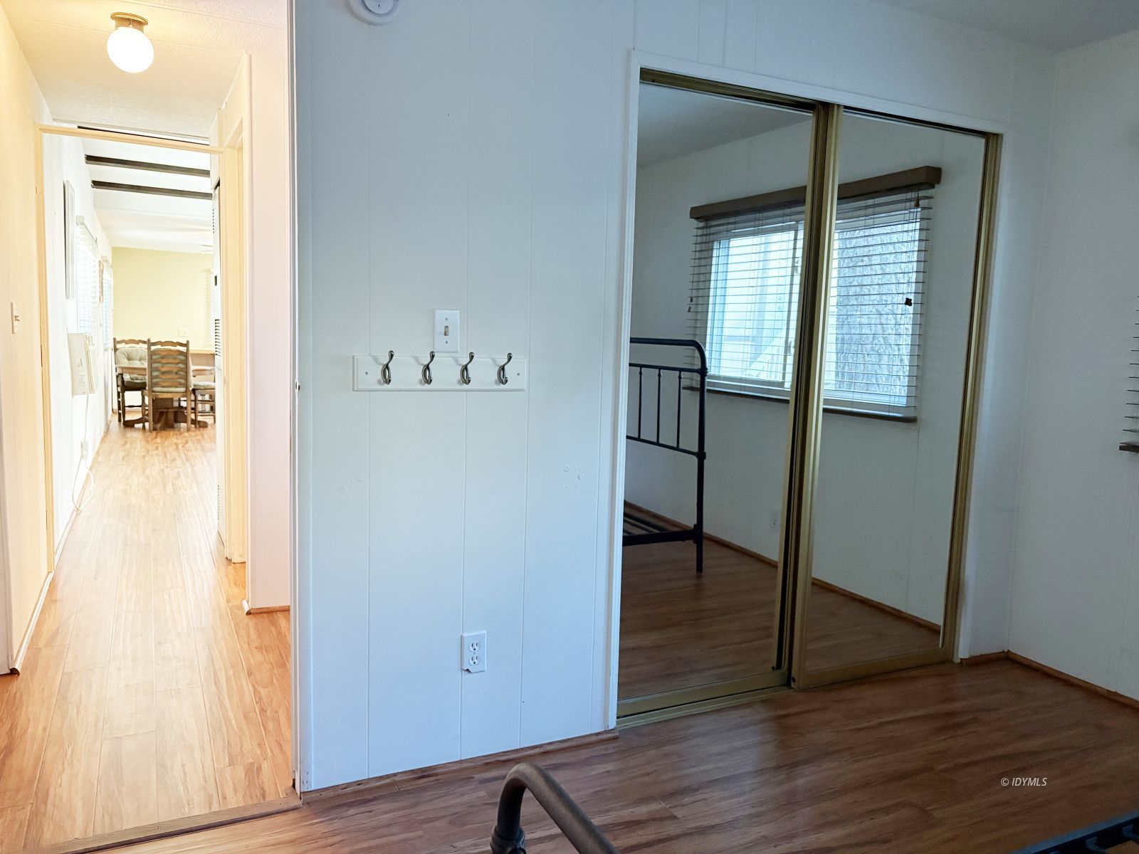 25955 Highway 243, Unit 25 Idyllwild, CA 92549 - Photo 26 of 38 a view of a hallway with wooden floor and a livingroom with furniture