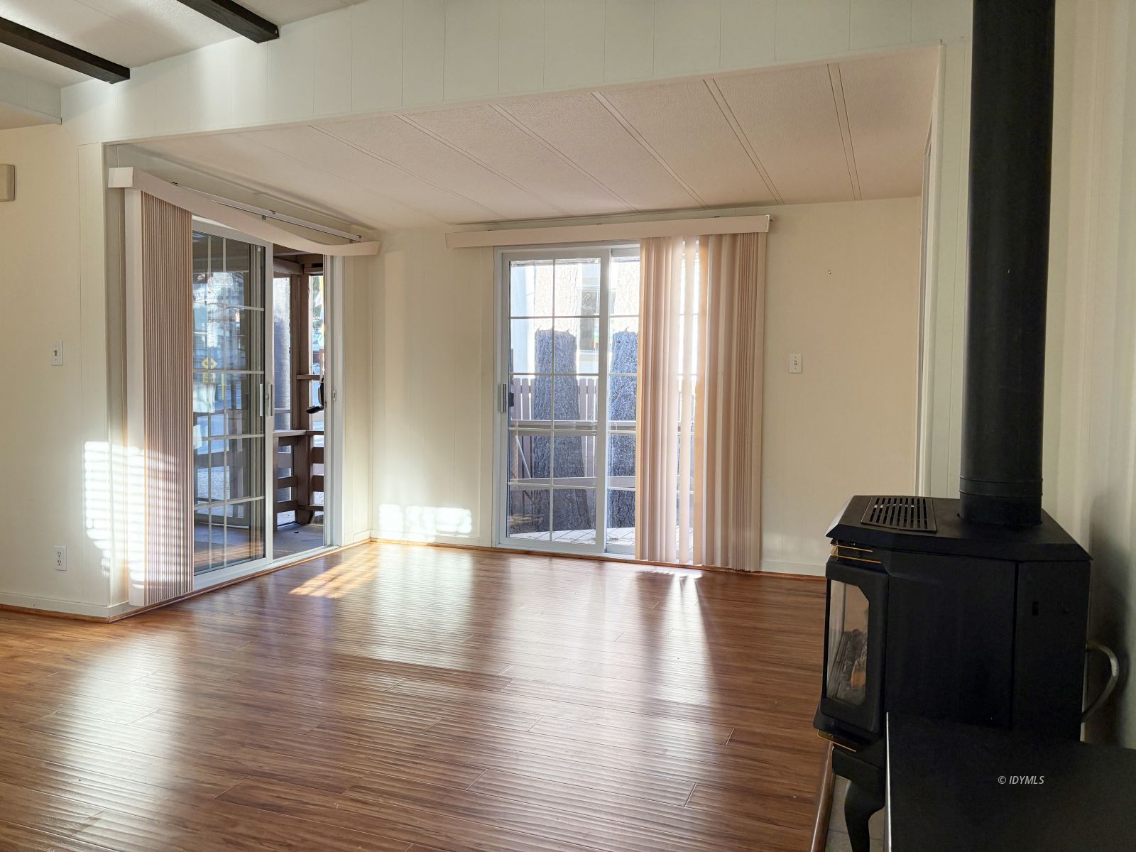 25955 Highway 243, Unit 25 Idyllwild, CA 92549 - Photo 6 of 38 a view of an empty room with wooden floor and a window