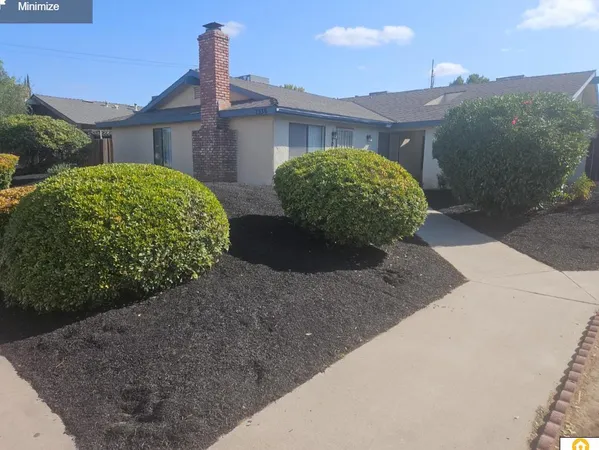 a view of a house with a yard and plants