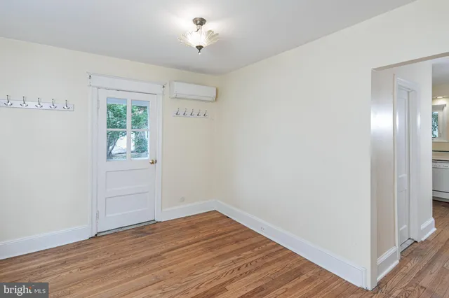 wooden floor in an empty room with a window