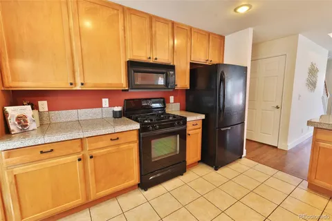 a kitchen with stainless steel appliances granite countertop a refrigerator stove and sink