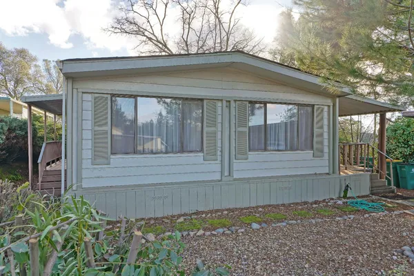 a front view of a house with a garden