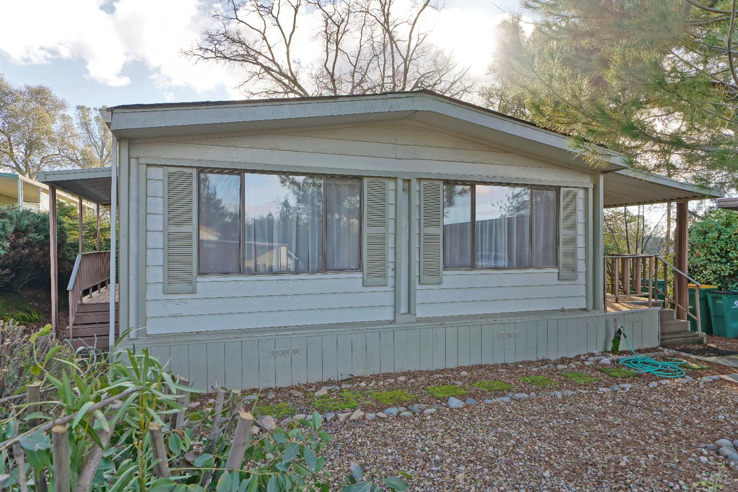 a front view of a house with a garden
