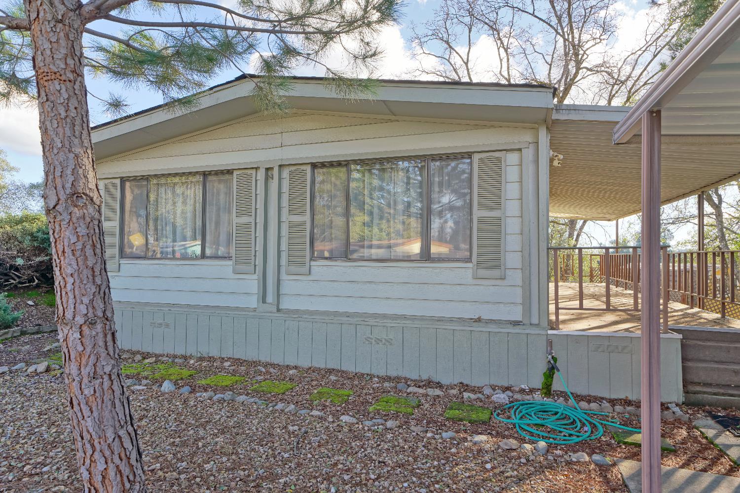 4420 Pleasant Valley Road, Unit 116 Diamond Springs, CA 95619 - Photo 24 of 28 a view of a house with a small yard and a large tree