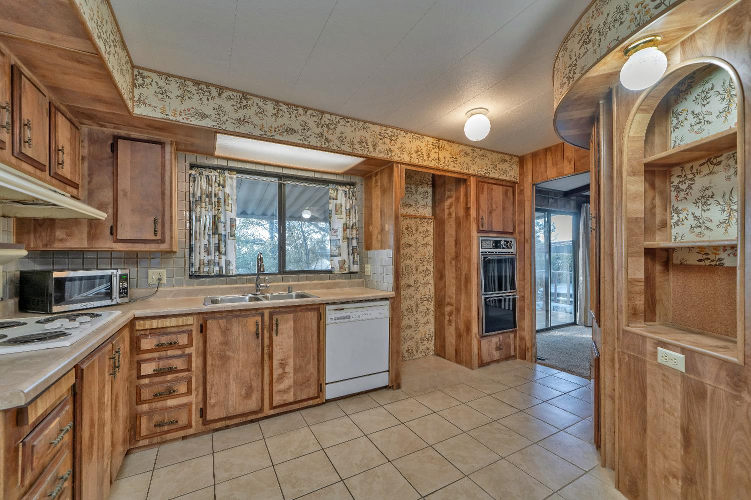 4420 Pleasant Valley Road, Unit 116 Diamond Springs, CA 95619 - Photo 6 of 28 a large kitchen with stainless steel appliances granite countertop a refrigerator and a sink
