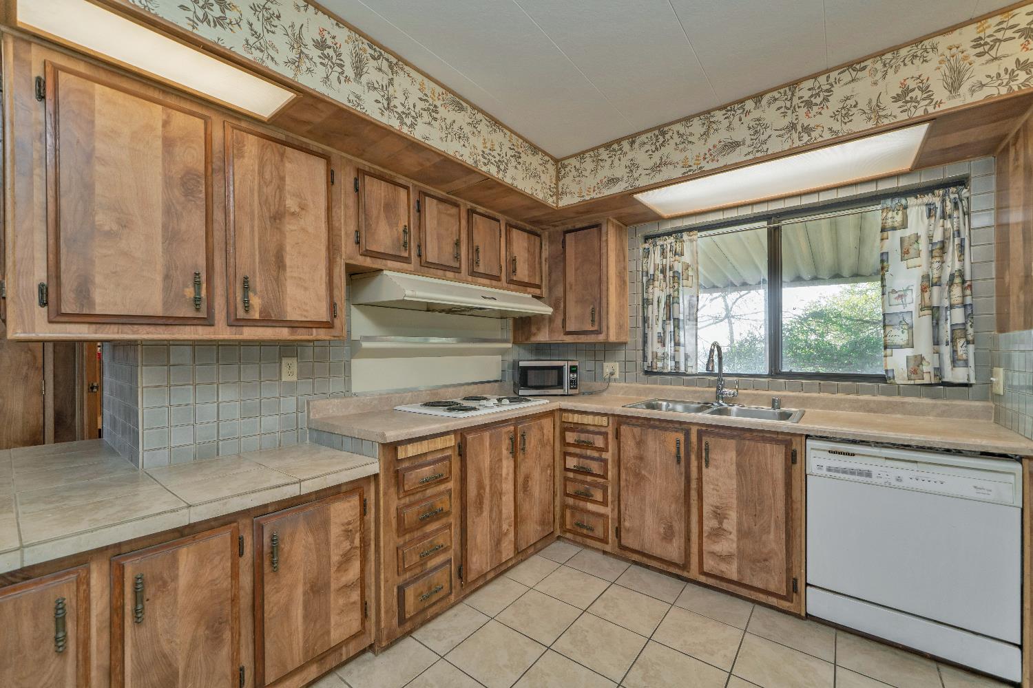 4420 Pleasant Valley Road, Unit 116 Diamond Springs, CA 95619 - Photo 7 of 28 a kitchen with a sink stove and cabinets
