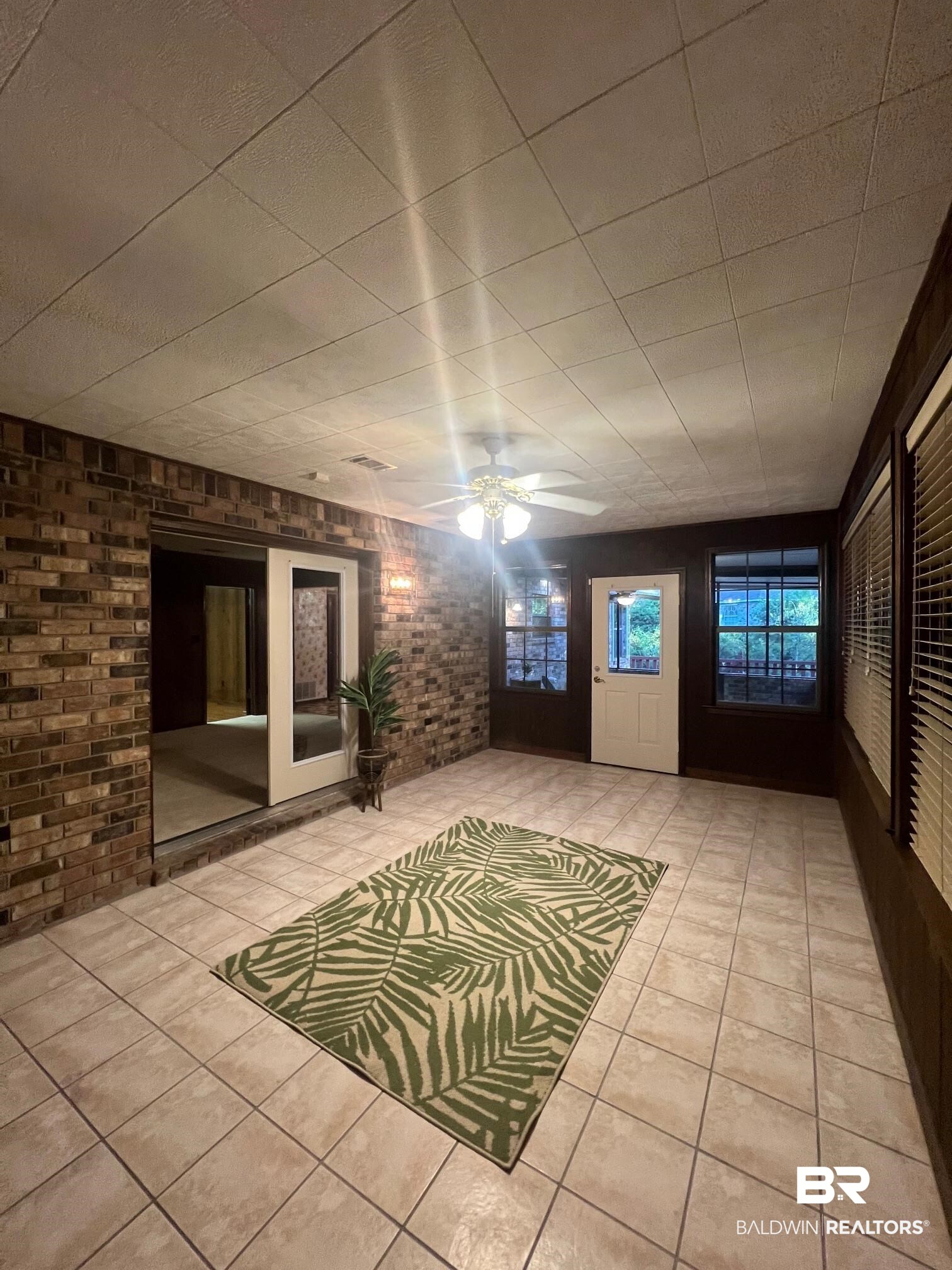 2240 Perdido Circle Lillian, AL 36549 - Photo 13 of 42 Interior space with ceiling fan and brick wall