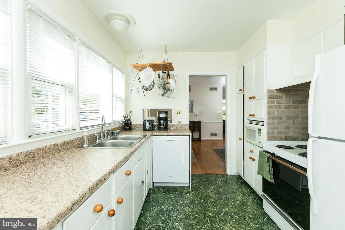 1331 Heather Hill Road Baltimore, MD 21239 - Photo 11 of 28 a kitchen with a sink stove and refrigerator