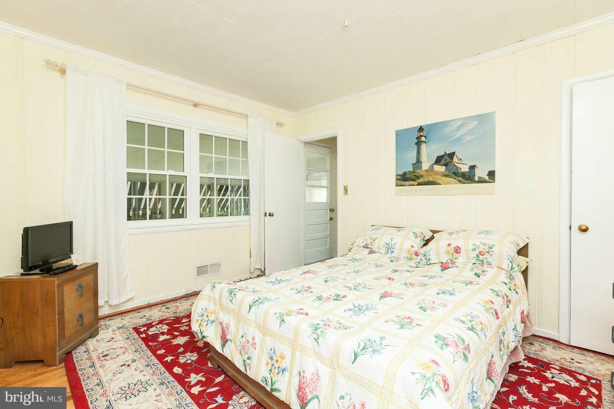 1331 Heather Hill Road Baltimore, MD 21239 - Photo 13 of 28 a bedroom with a bed and a television
