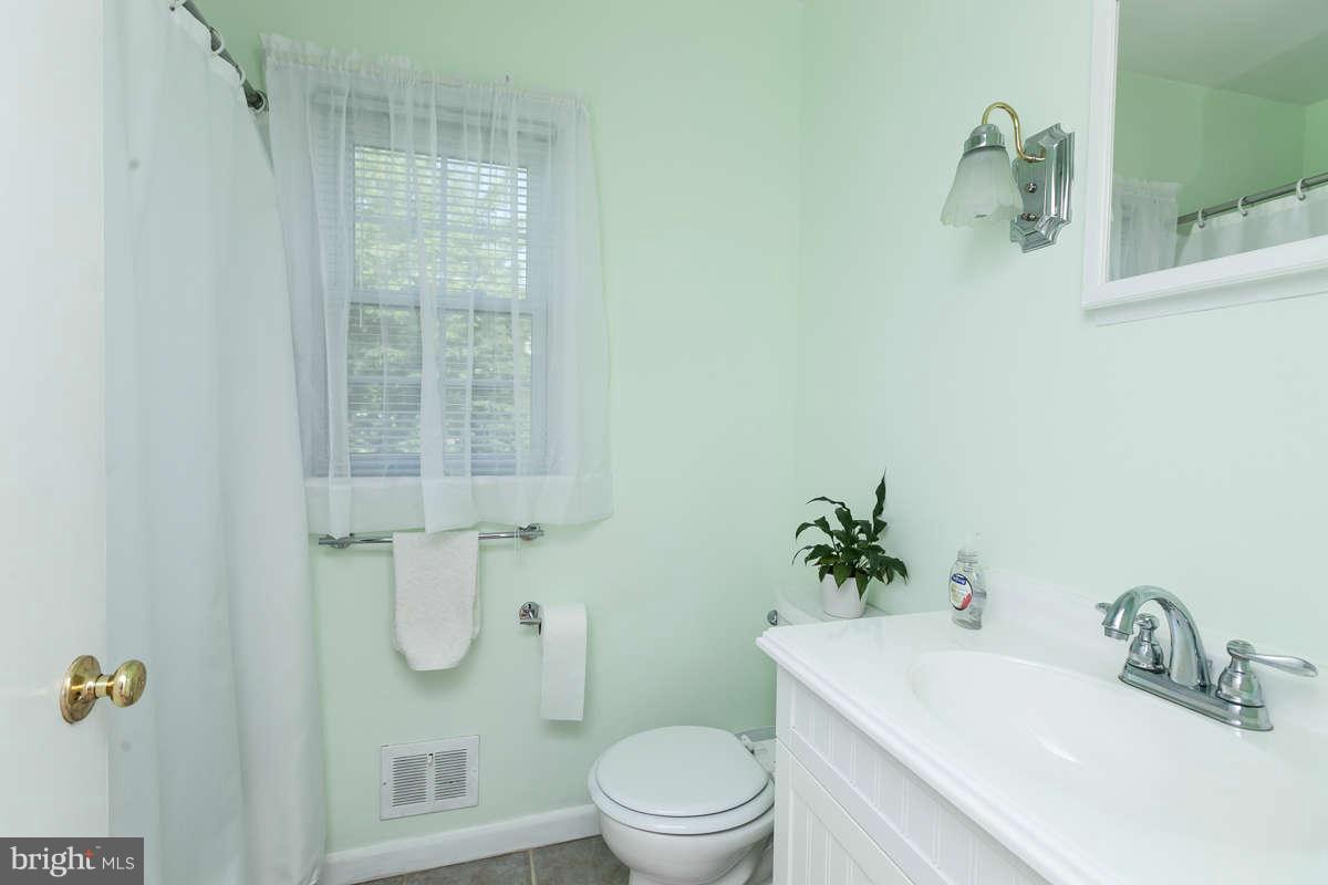 1331 Heather Hill Road Baltimore, MD 21239 - Photo 15 of 28 a bathroom with a sink toilet and shower