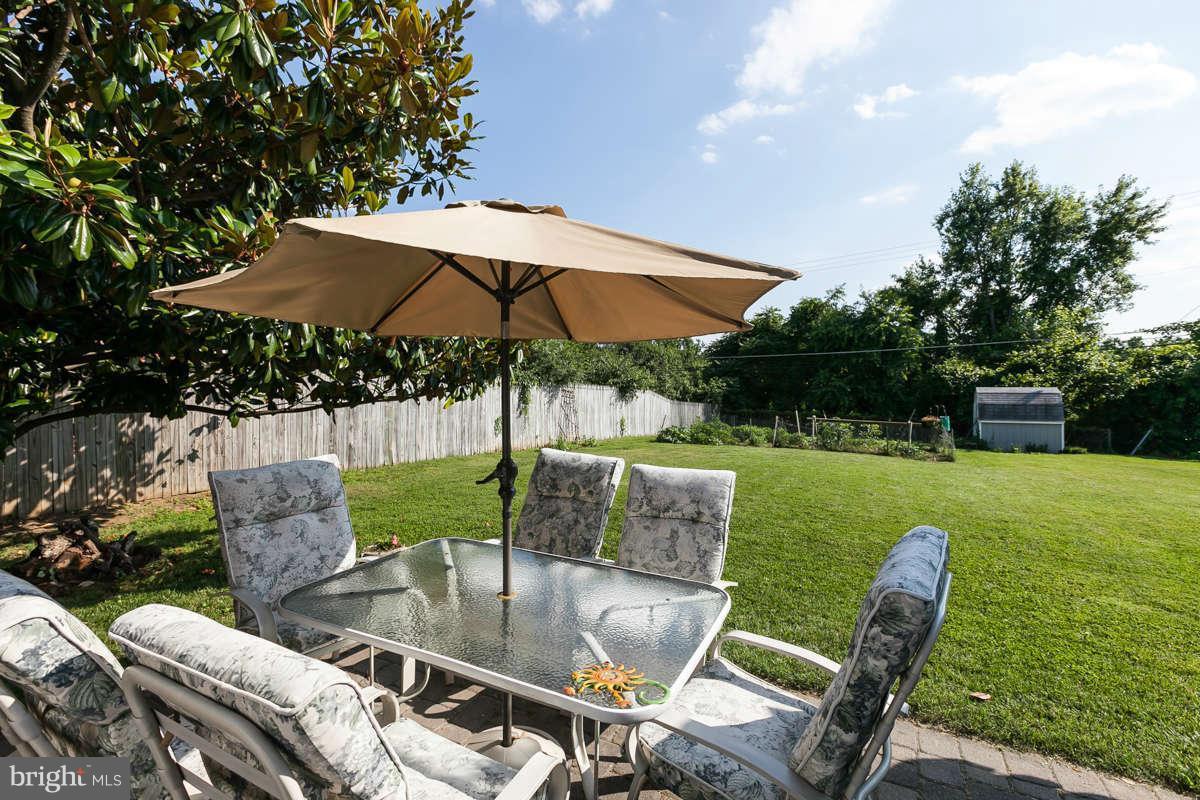 1331 Heather Hill Road Baltimore, MD 21239 - Photo 22 of 28 a patio with a yard table and chairs