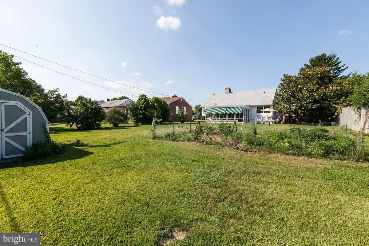 1331 Heather Hill Road Baltimore, MD 21239 - Photo 25 of 28 a view of a big yard with a house and a lots of green space