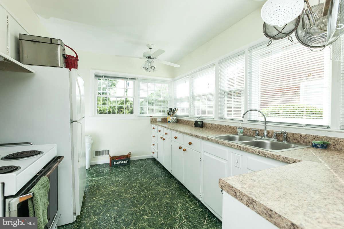 1331 Heather Hill Road Baltimore, MD 21239 - Photo 10 of 28 a kitchen with granite countertop a sink and a stove