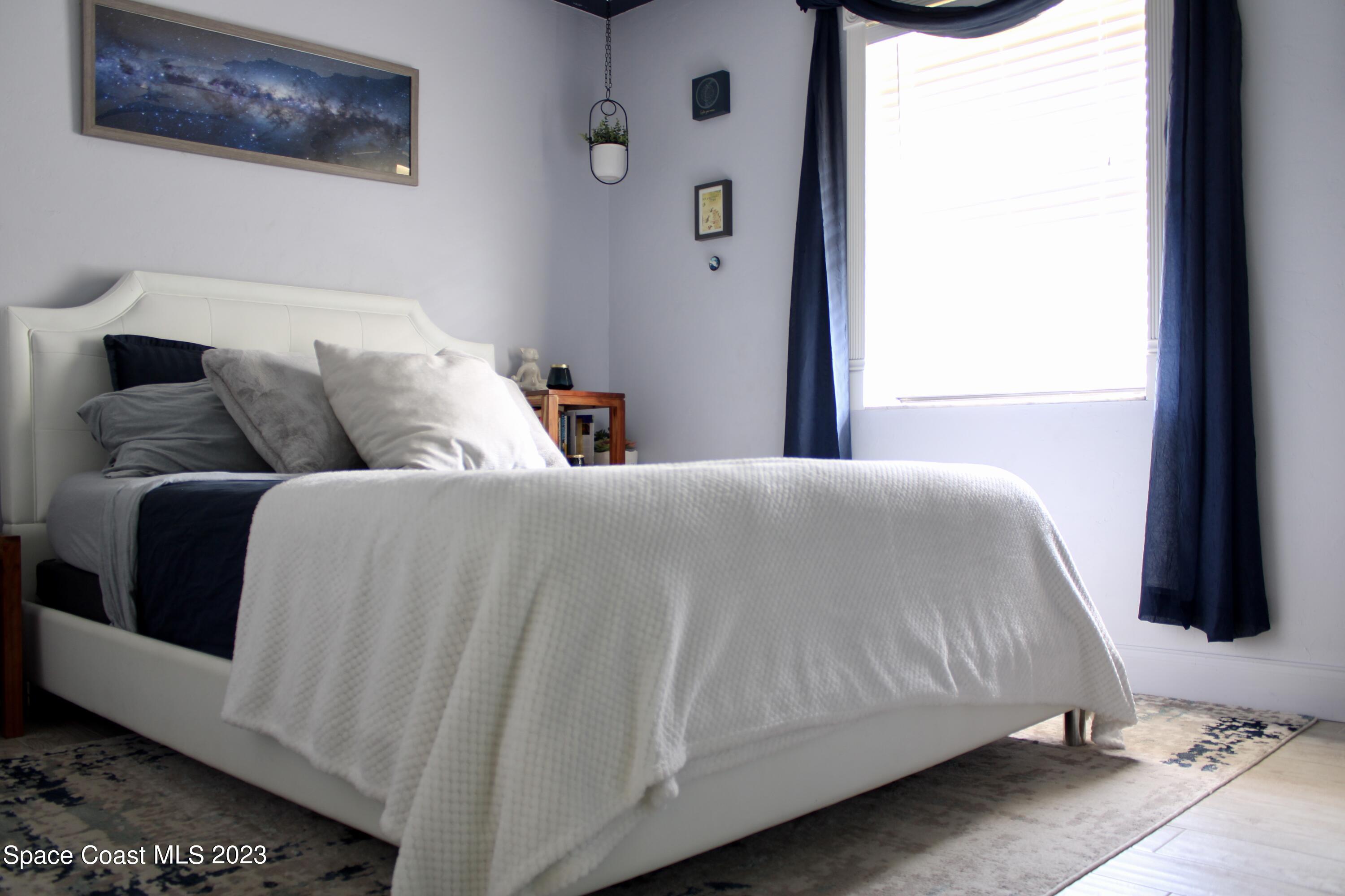 17416 Thrush Drive Jupiter, FL 33458 - Photo 23 of 28 a bedroom with a bed and a window