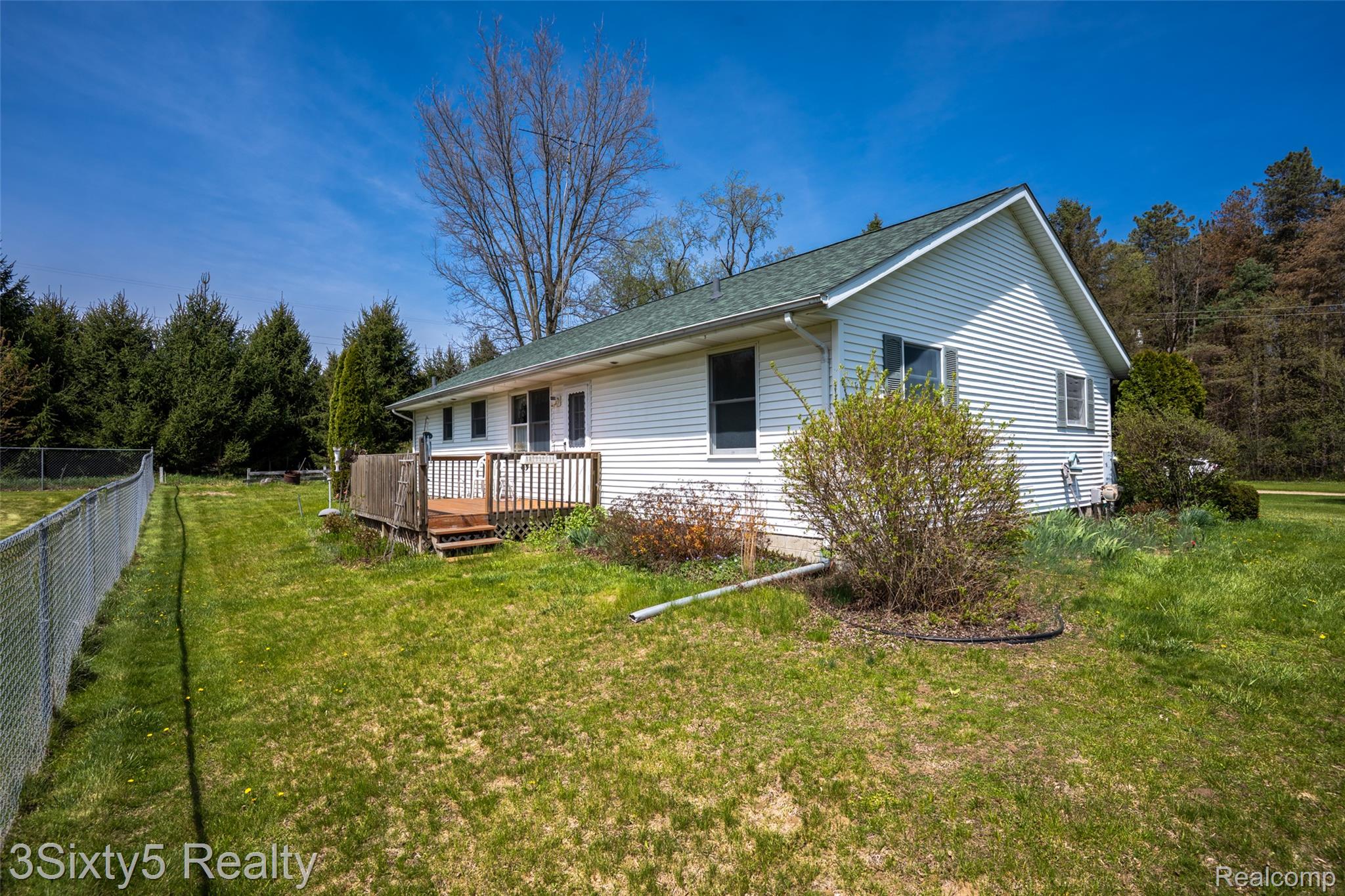1783 Farnsworth Road Lapeer, MI 48446 - Photo 10 of 51 View of property exterior with a wooden deck and roof with shingles