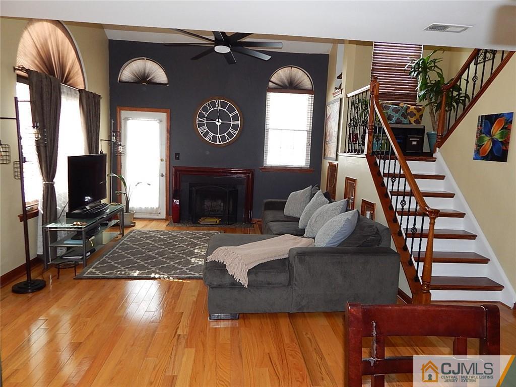 5202 Stonehedge Road, Unit 5202 Edison, NJ 08820 - Photo 3 of 28 a living room with furniture and a fireplace