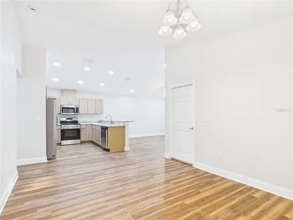 a view of kitchen dining table wooden floor and kitchen view