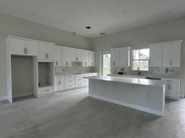 a view of a kitchen with a sink and a refrigerator