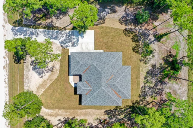 an aerial view of a house with a yard and garden