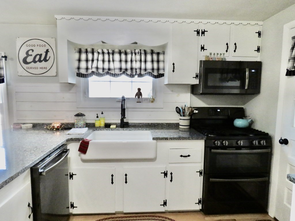 12 Sawmill Road Dudley, MA 01571 - Photo 17 of 37 a kitchen with stainless steel appliances a stove a sink and a white cabinets