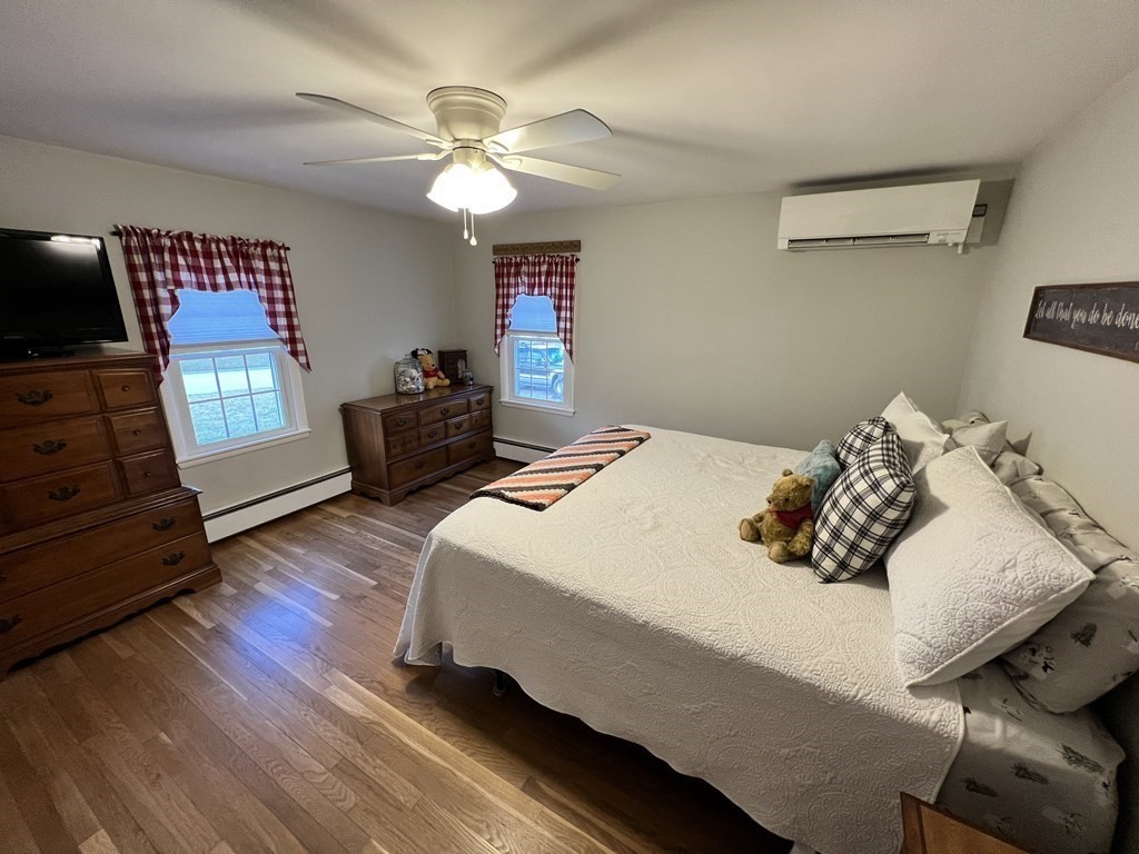 12 Sawmill Road Dudley, MA 01571 - Photo 26 of 37 a bedroom with a bed and wooden floor